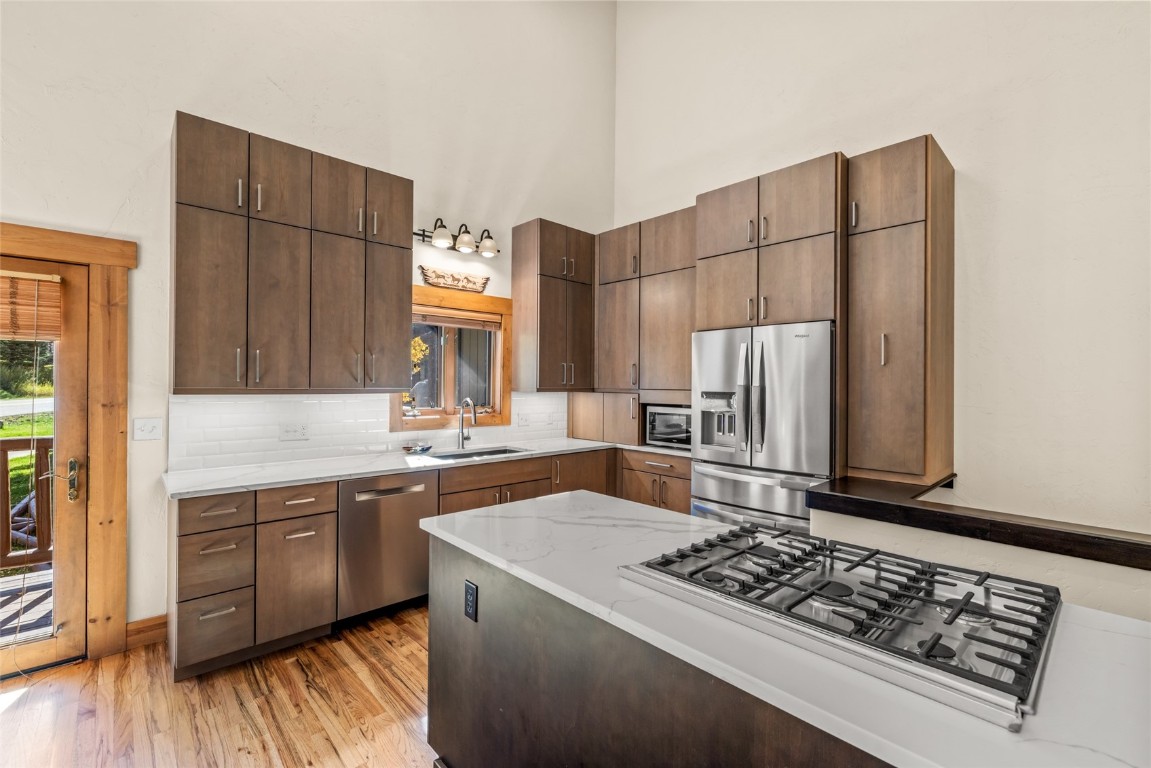 1775 Latigo Loop Steamboat Springs, CO 80487 - Photo 11 of 31 a kitchen with stainless steel appliances a stove a sink and a refrigerator