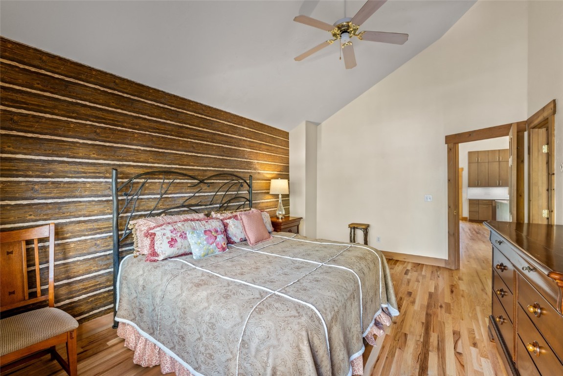 1775 Latigo Loop Steamboat Springs, CO 80487 - Photo 14 of 31 a bedroom with a bed and a chandelier