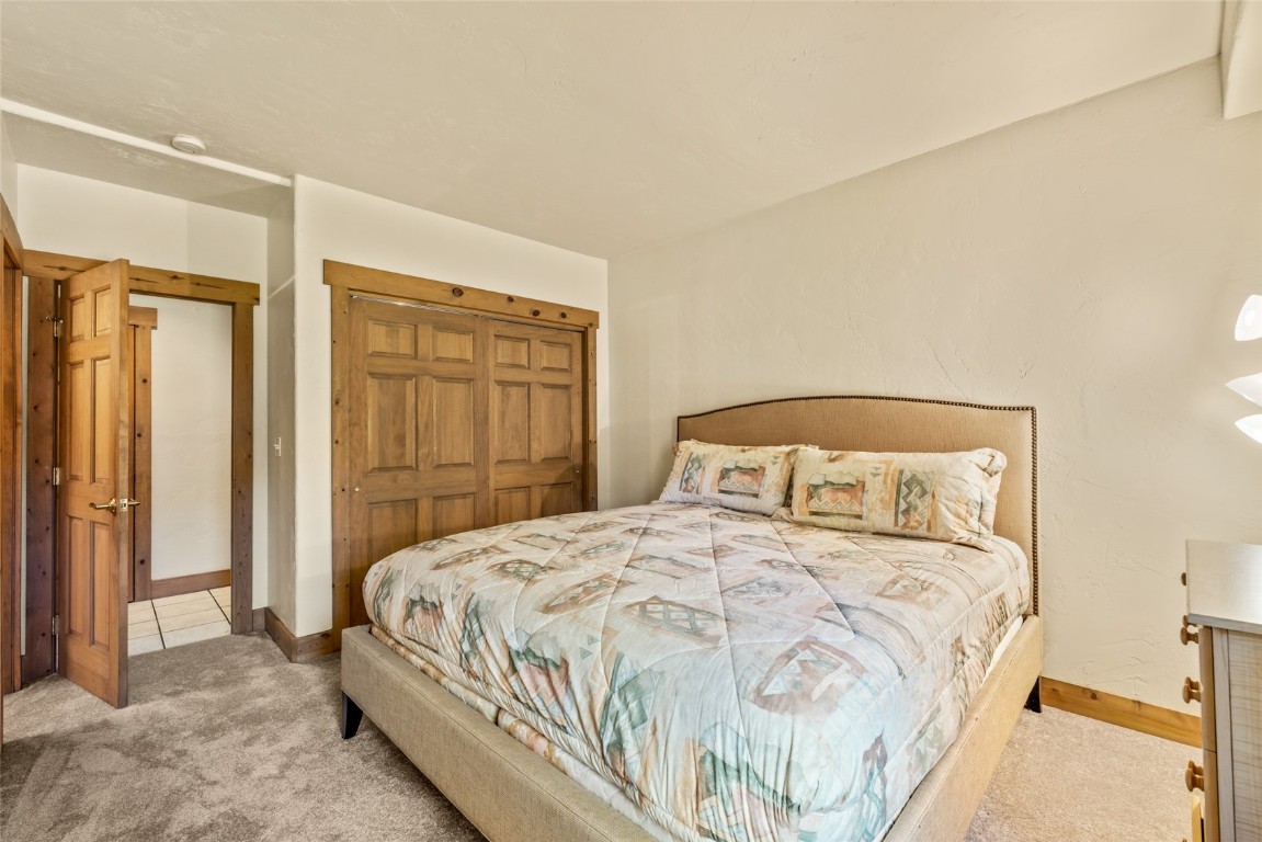 1775 Latigo Loop Steamboat Springs, CO 80487 - Photo 19 of 31 a bedroom with a bed and a mirror