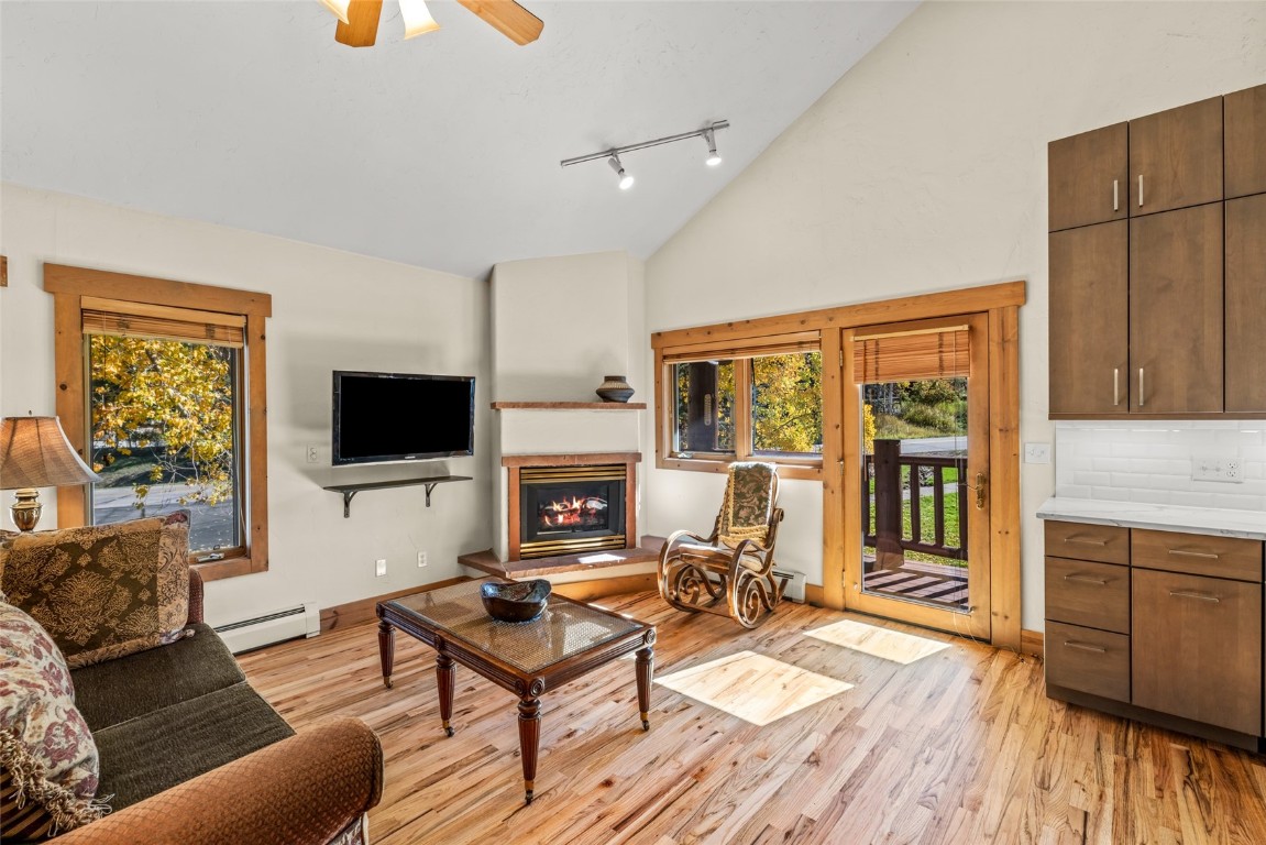 1775 Latigo Loop Steamboat Springs, CO 80487 - Photo 3 of 31 a living room with furniture a flat screen tv and a fireplace