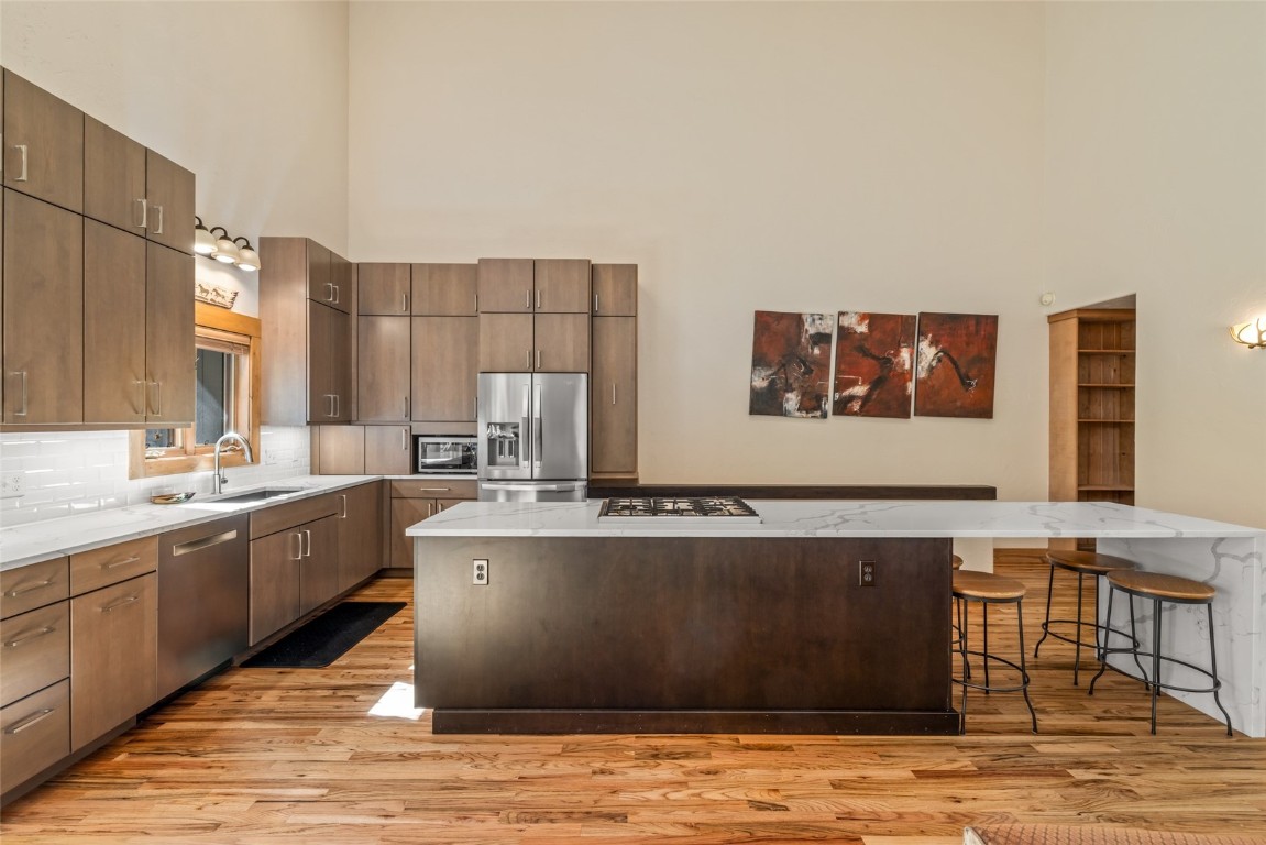 1775 Latigo Loop Steamboat Springs, CO 80487 - Photo 8 of 31 a large kitchen with stainless steel appliances granite countertop a large counter top and a stove