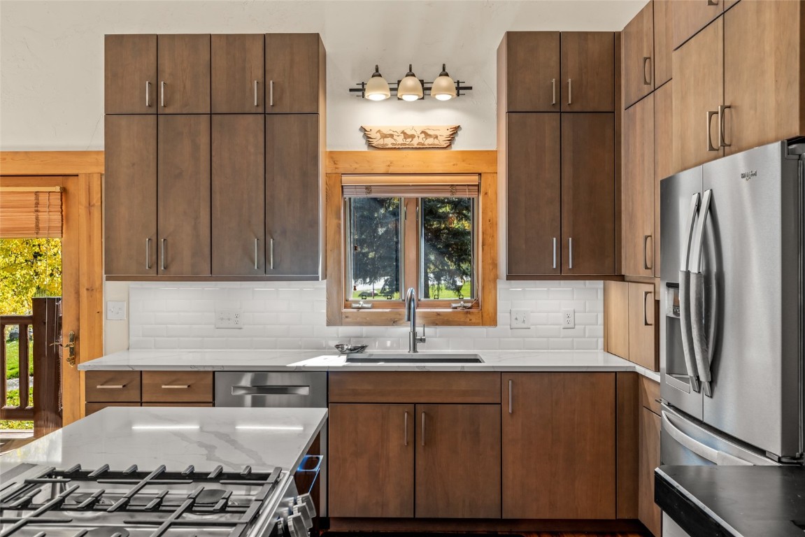 1775 Latigo Loop Steamboat Springs, CO 80487 - Photo 9 of 31 a kitchen with stainless steel appliances granite countertop a refrigerator a sink a stove and a refrigerator