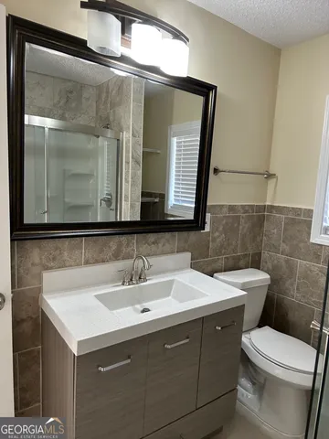 a view of a livingroom with an empty space and a window