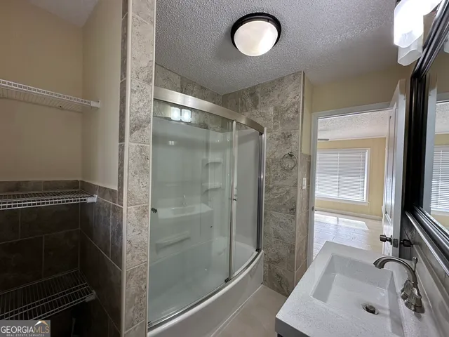a view of an empty room with a fireplace and a window