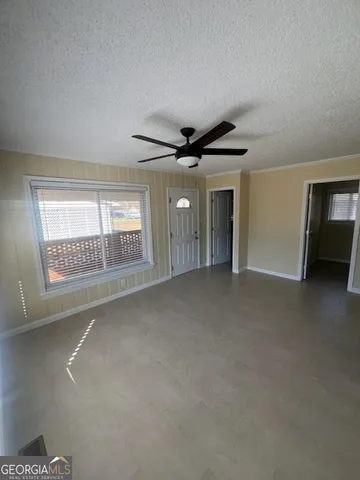 a living room with stainless steel appliances granite countertop furniture wooden floor and a view of kitchen