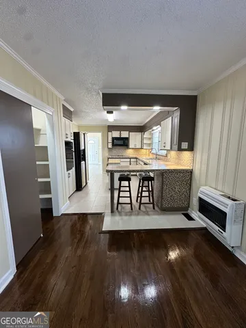 a view of empty room with wooden floor and window