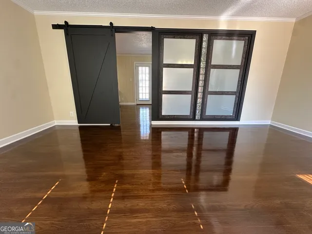 a view of a livingroom with wooden floor and window