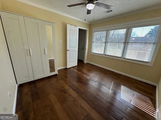 a kitchen with granite countertop a sink cabinets and stainless steel appliances