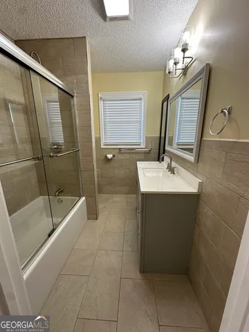 a view of a room with wooden floor and ceiling fan