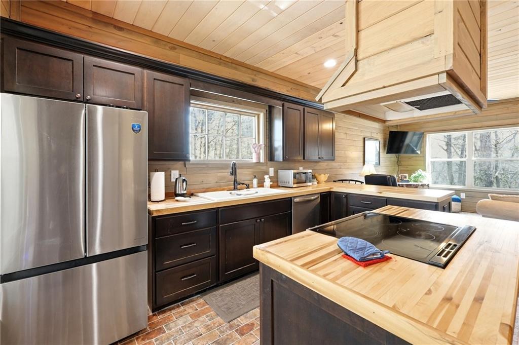 1041 Astro Court Northeast Ranger, GA 30734 - Photo 6 of 52 a kitchen with a refrigerator a sink and cabinets