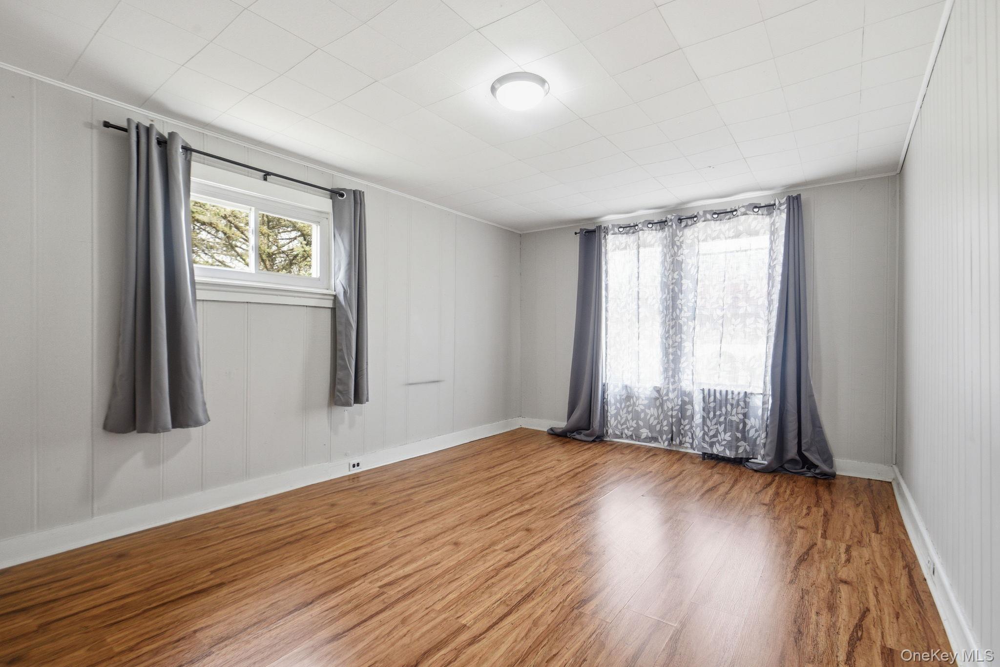 97 Maple Street Newburgh, NY 12550 - Photo 20 of 31 Unfurnished room featuring wood finished floors and healthy amount of natural light
