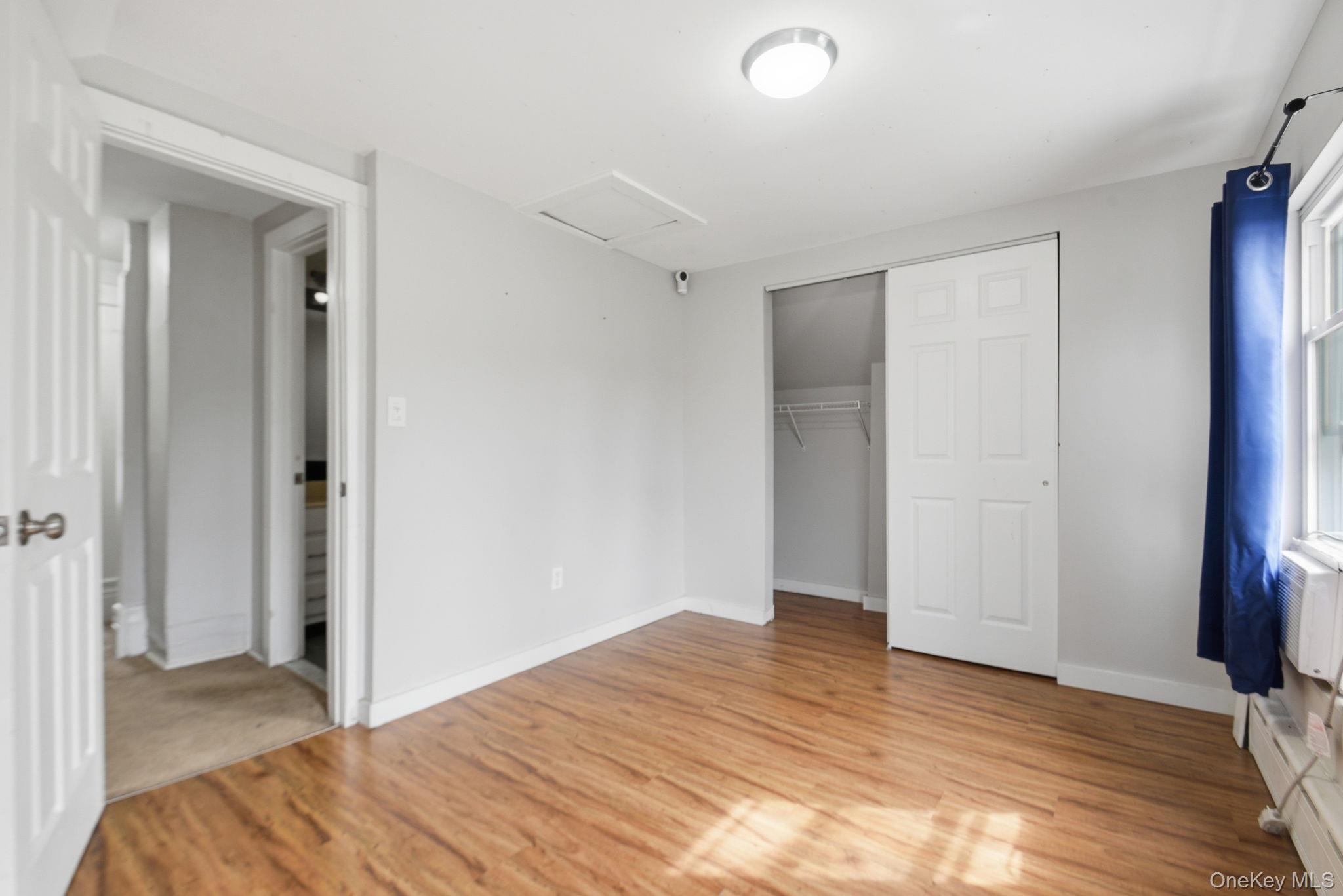 97 Maple Street Newburgh, NY 12550 - Photo 23 of 31 Unfurnished bedroom featuring light wood-style flooring and a closet