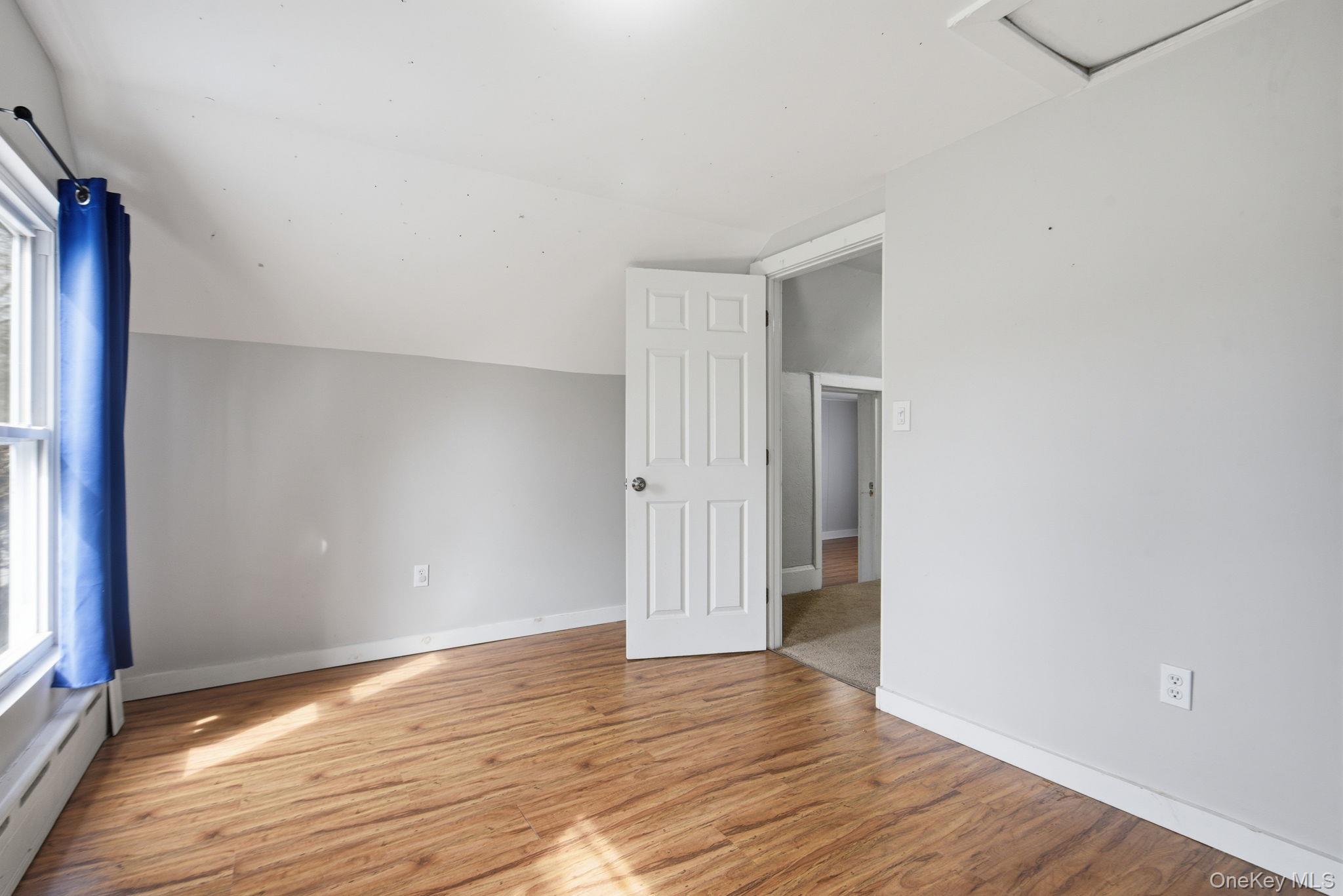 97 Maple Street Newburgh, NY 12550 - Photo 24 of 31 Bonus room featuring vaulted ceiling, light wood-type flooring, and a baseboard heating unit