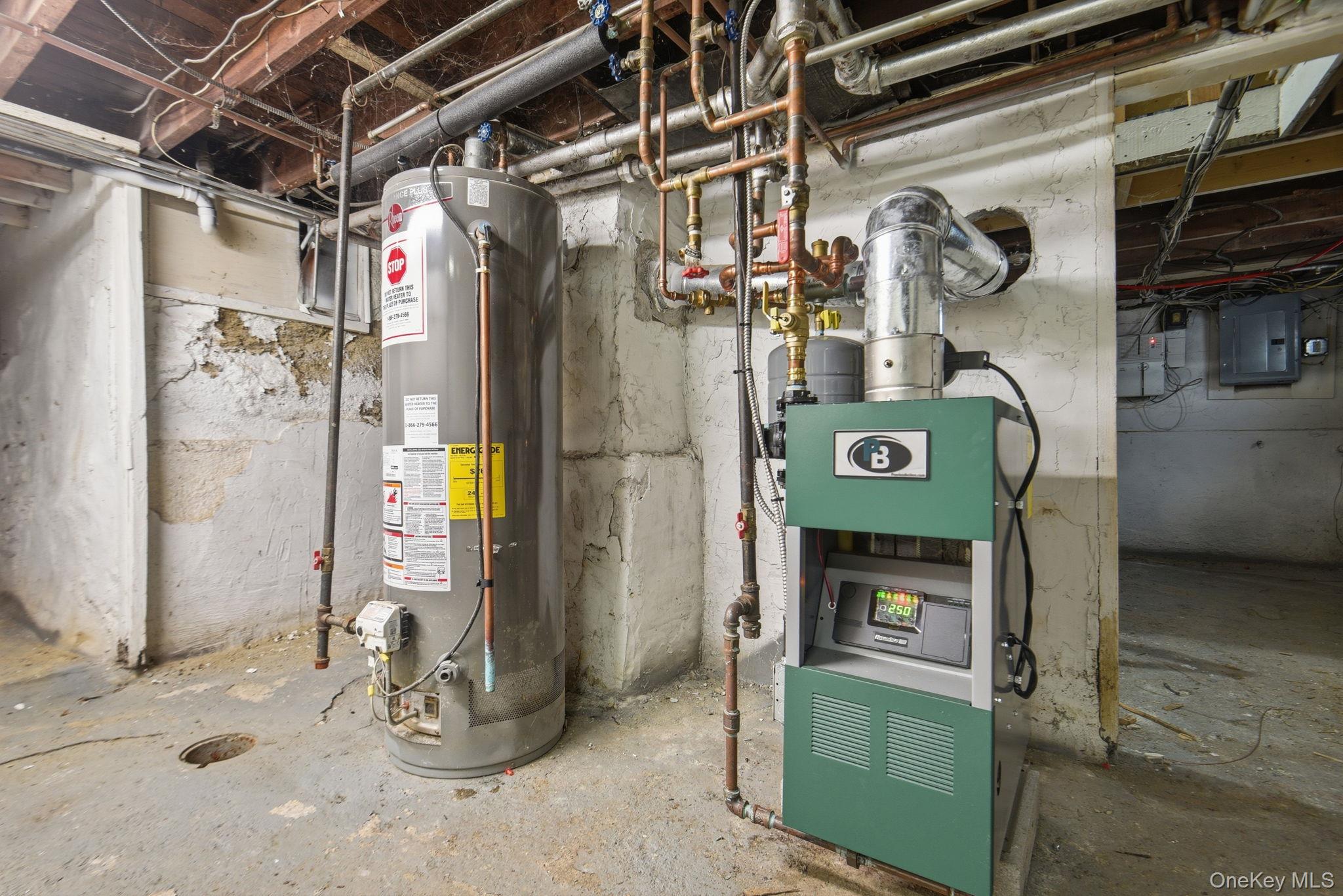 97 Maple Street Newburgh, NY 12550 - Photo 28 of 31 Utility room featuring water heater, electric panel, and a heating unit
