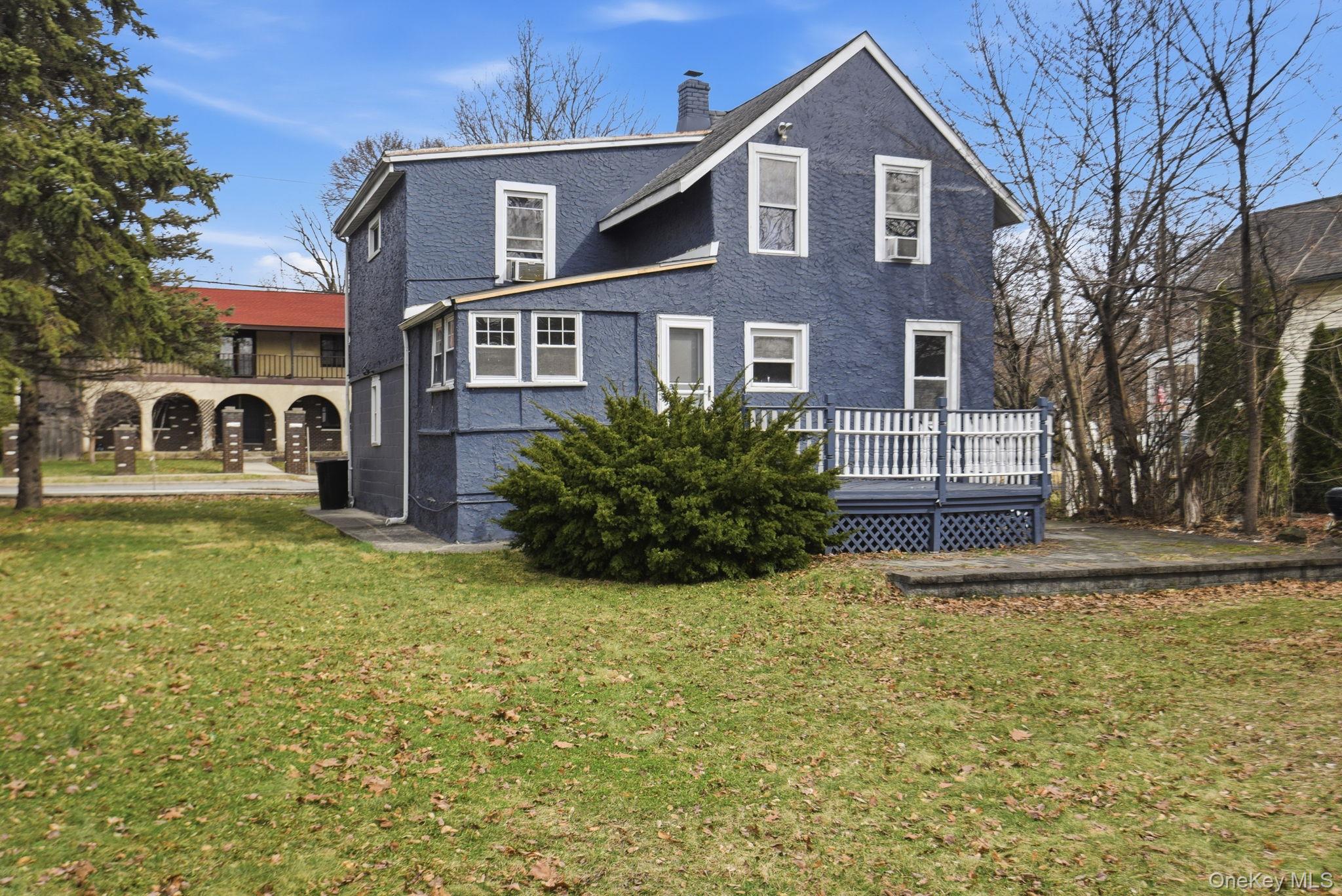 97 Maple Street Newburgh, NY 12550 - Photo 29 of 31 Back of house featuring a chimney, a yard, and a deck