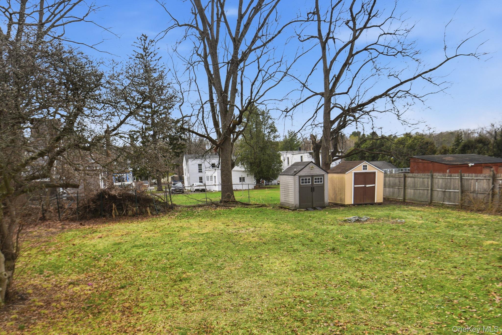 97 Maple Street Newburgh, NY 12550 - Photo 31 of 31 Fenced backyard with a storage unit and a residential view