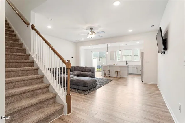 a view of an entryway with wooden floor and staircase