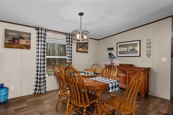 a view of a dining room with furniture wooden floor and a chandelier