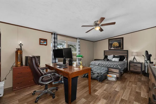 a work room with furniture and wooden floor