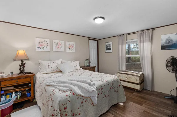 a bedroom with a bed and a window