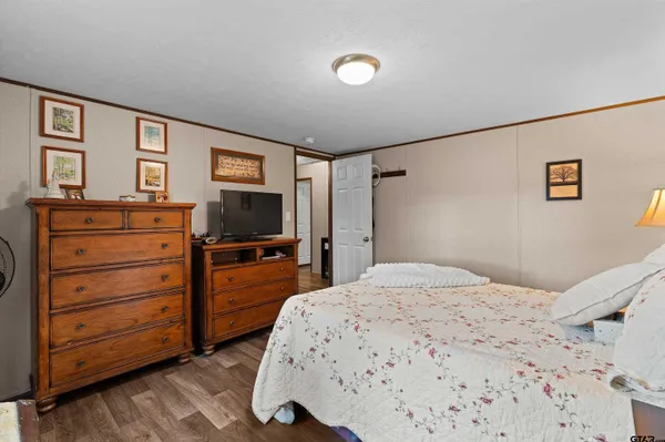 a bedroom with a bed and a television
