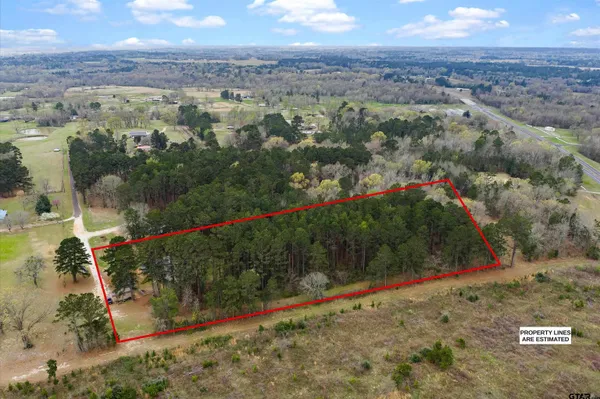 an aerial view of a houses with a yard