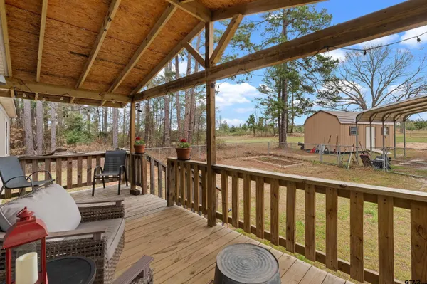 a view of a chair and tables in the balcony