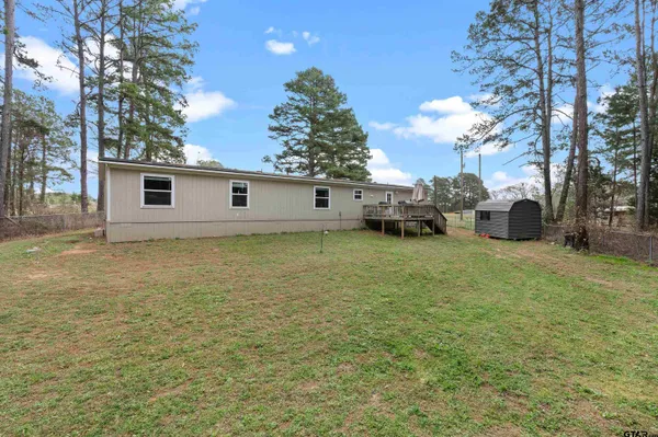 a view of a house with a yard and garage