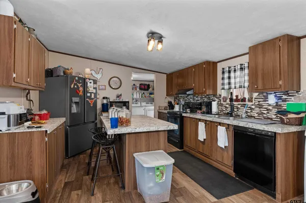 a kitchen that has a lot of cabinets a sink and a stove in it