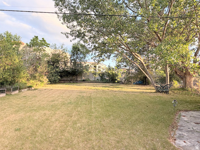 737 Wasatch Street Midvale, UT 84047 - Photo 23 of 29 Spacious yard with established trees, expansive lawn, and concrete patio area