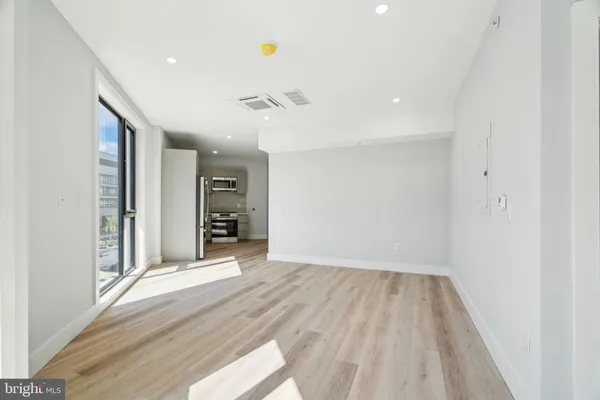 a view of a big room with windows and entryway