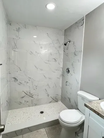 an empty room with windows and closet area