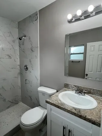 a bathroom with a toilet and a shower