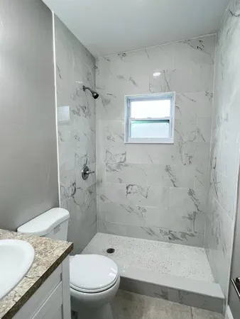 an empty room with windows and closet