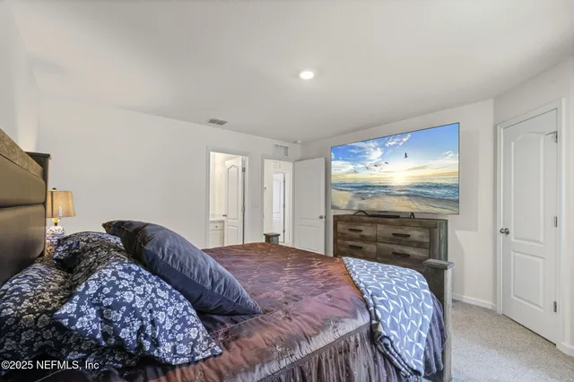 a bedroom with a bed and a television