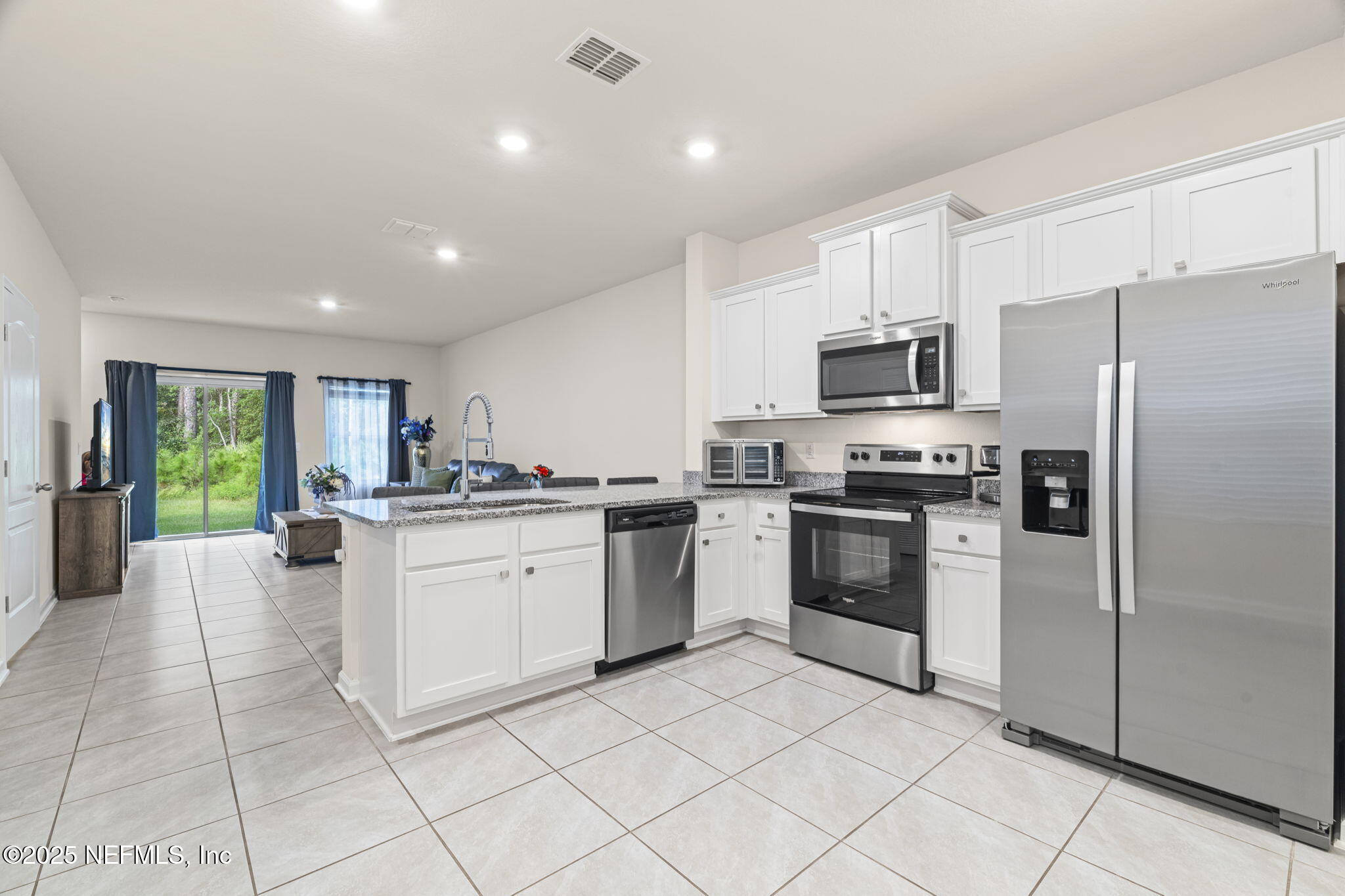 263 Talulla Trail St. Augustine, FL 32095 - Photo 2 of 32 a kitchen with cabinets and stainless steel appliances