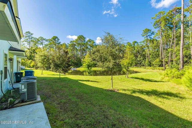 aerial view of a residential apartment building with a yard and plants