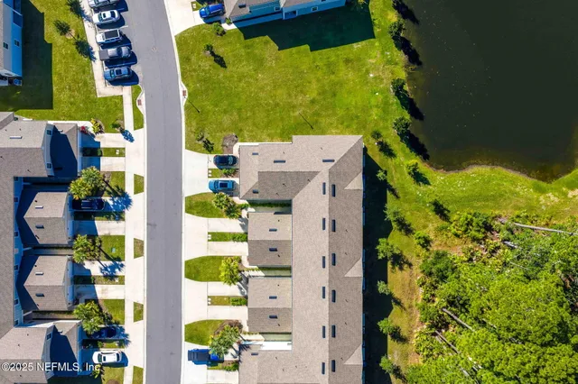 an aerial view of a house with a swimming pool yard and outdoor seating