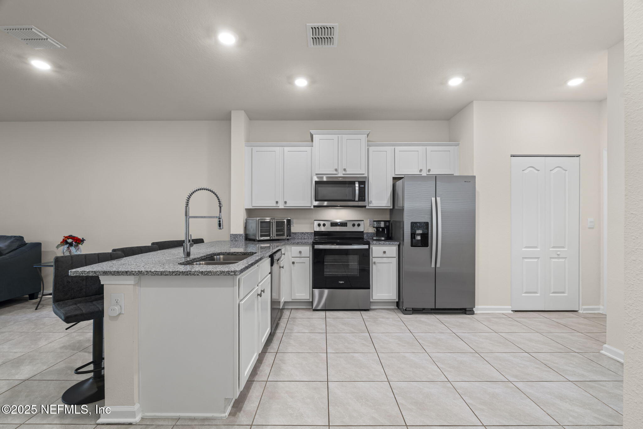 263 Talulla Trail St. Augustine, FL 32095 - Photo 6 of 32 a kitchen with a sink a refrigerator and cabinets