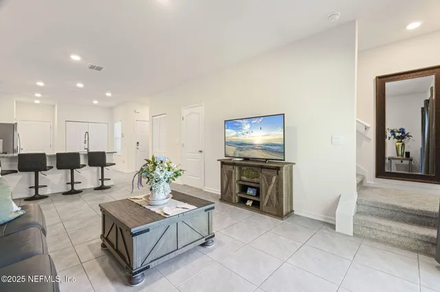 a living room with furniture a flat screen tv and a fireplace