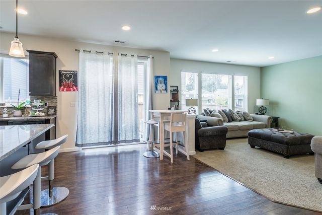a living room with furniture window and wooden floor