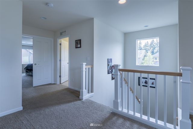 a view of a hallway with a window and a livingroom