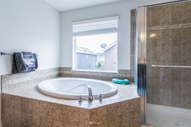 a bath tub sitting in a bathroom next to a window