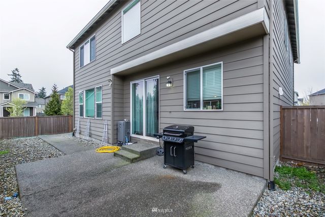 a view of backyard with a chair and table