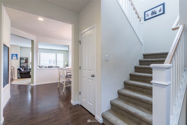 a view of entryway and hall with wooden floor