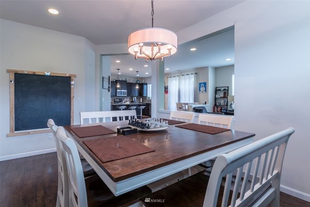 a view of a dining room with furniture and chandelier