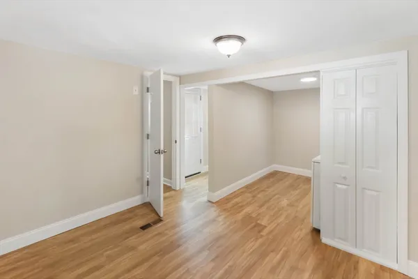 a view of storage and utility room with wooden floor