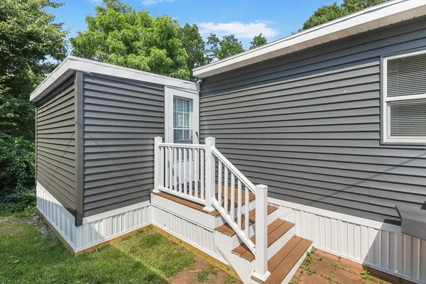 a kitchen with a table chairs refrigerator and cabinets