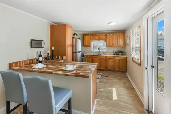 a kitchen with stainless steel appliances granite countertop a refrigerator sink and cabinets