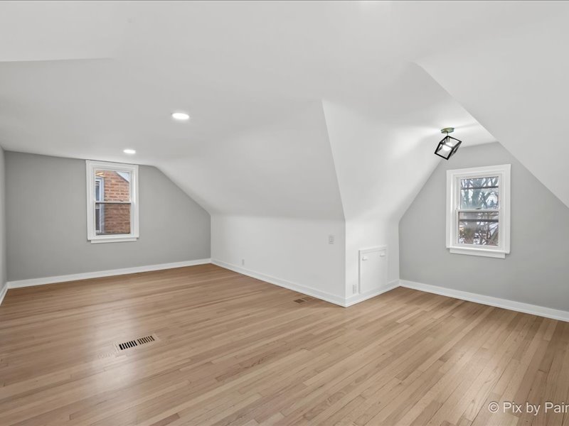 3922 West 59th Place Chicago, IL 60629 - Photo 11 of 29 an empty room with wooden floor and windows